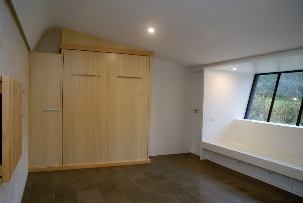 An Empty Room With A Wooden Wall And A Window — South Coast Glass In South Nowra, NSW