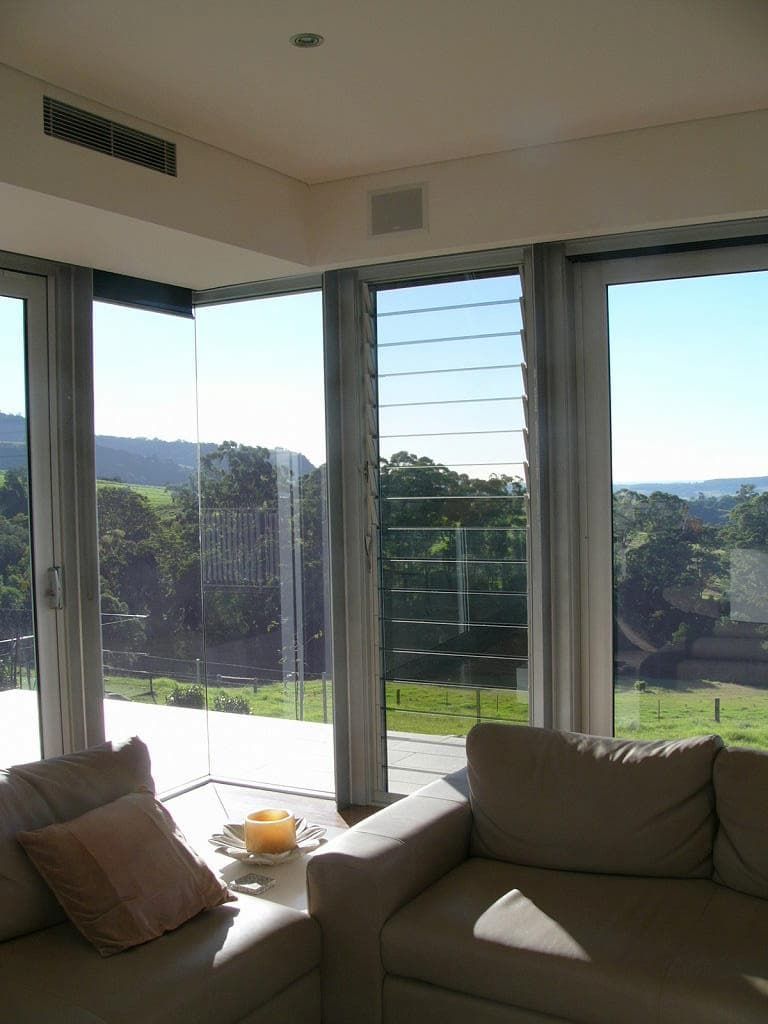 A Living Room With A Couch And Lots Of Windows — South Coast Glass In South Nowra, NSW