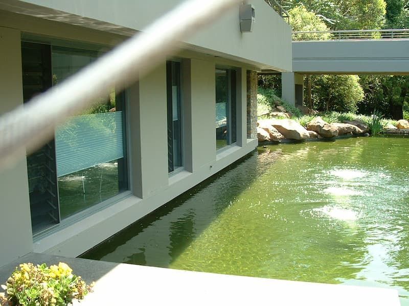 A Large Building With A Pond In Front Of It — South Coast Glass In South Nowra, NSW