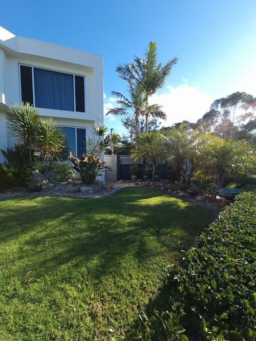 A White House With A Lush Green Lawn In Front Of It — South Coast Glass In South Nowra, NSW