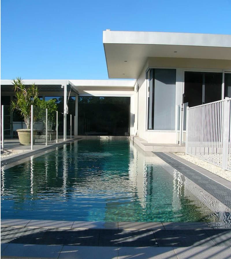 A House With A Large Swimming Pool In Front Of It — South Coast Glass In South Nowra, NSW