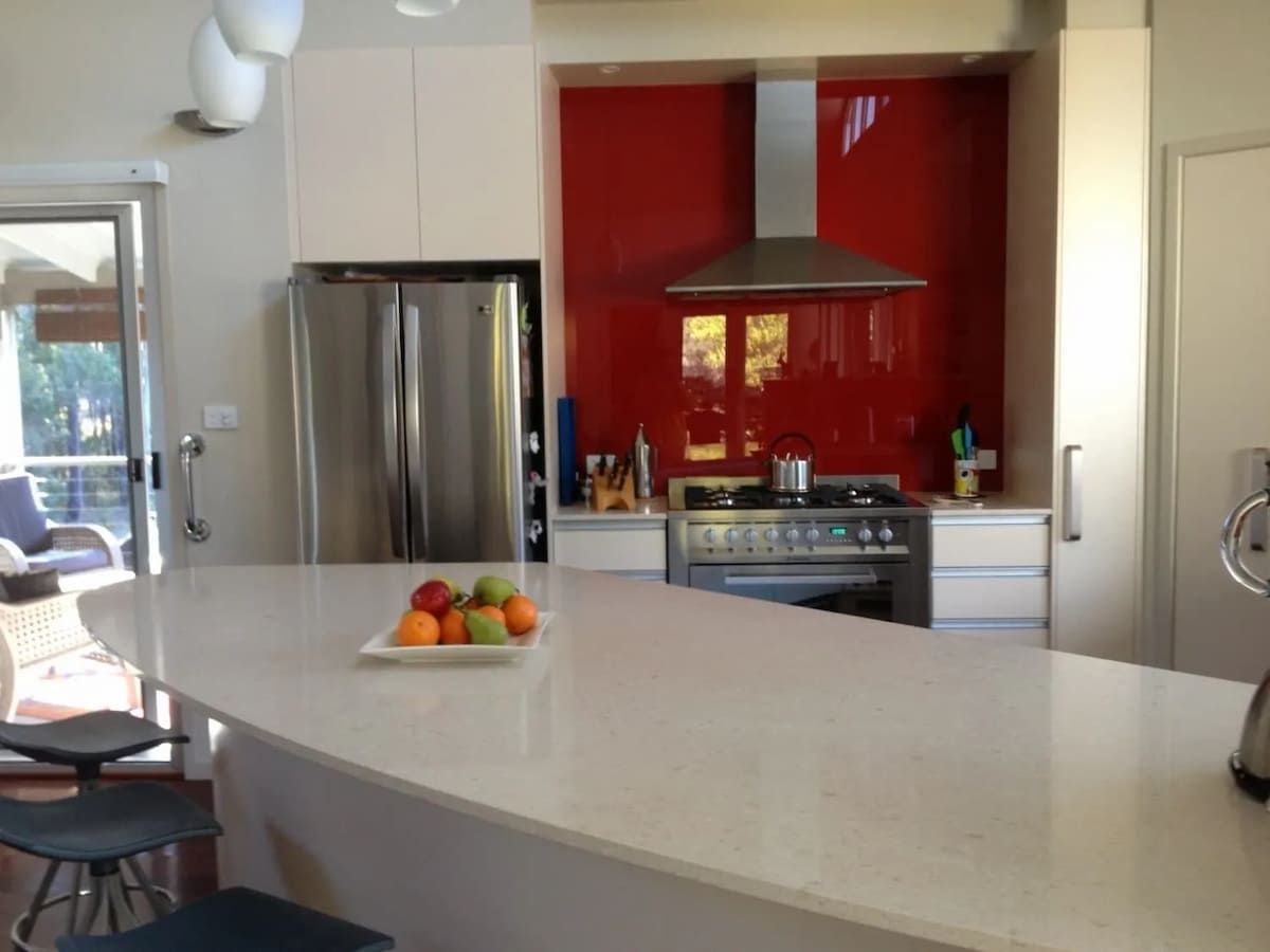 A Kitchen With A White Counter Top And A Bowl Of Fruit On It — South Coast Glass In South Nowra, NSW