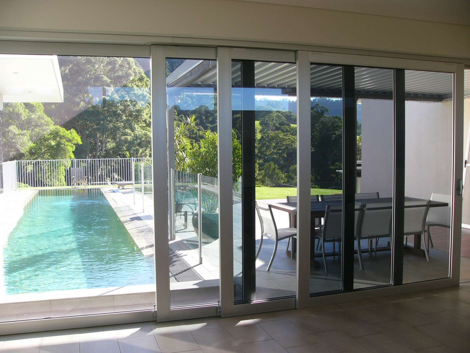 A House with Glass Sliding Door and Pool in Front — South Coast Glass In South Nowra, NSW