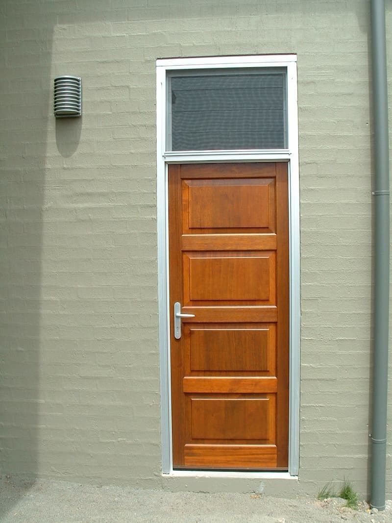 A Wooden Door On A Brick Wall With A Window Above It — South Coast Glass In South Nowra, NSW