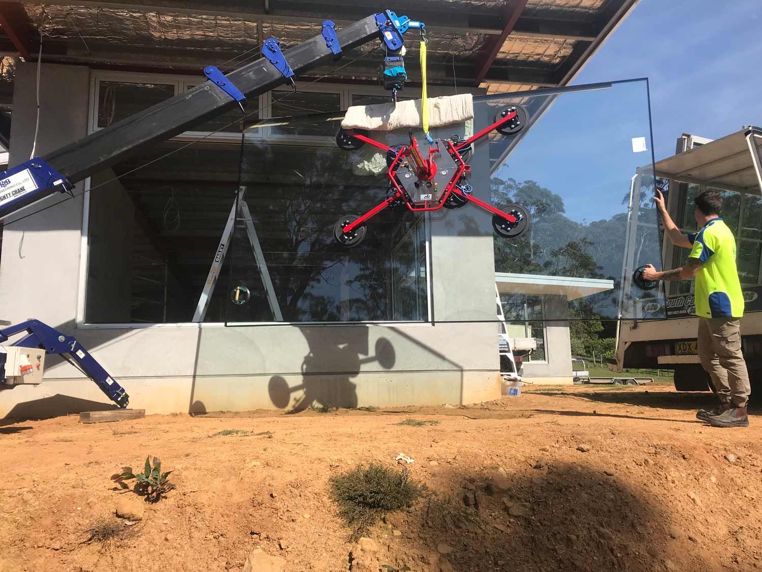 A Truck Installing Glass Wall in a House Construction — South Coast Glass In South Nowra, NSW