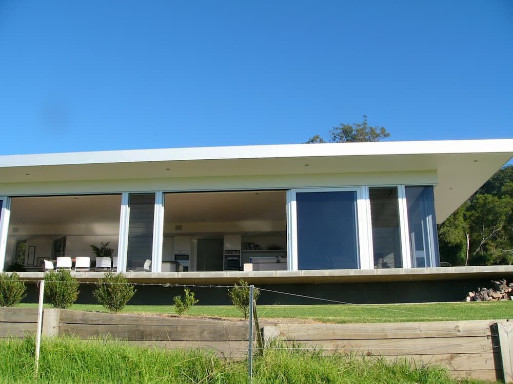 A Large White House With A Lot Of Windows — South Coast Glass In South Nowra, NSW