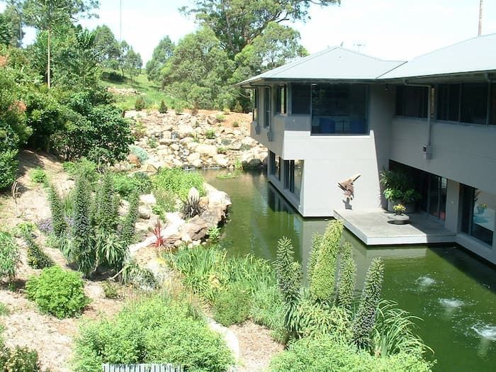 A Large Building With A Pond In Front Of It — South Coast Glass In South Nowra, NSW