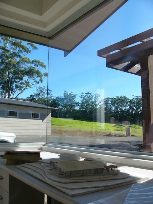 A Model Of A House Sits On A Table In Front Of A Window — South Coast Glass In South Nowra, NSW