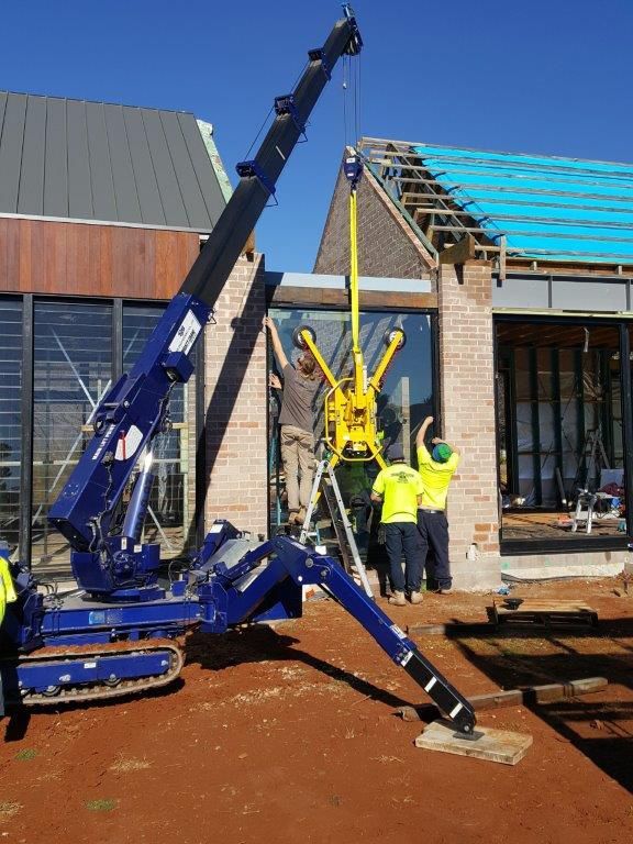 A Truck Installing Glass Wall in a House — South Coast Glass In South Nowra, NSW