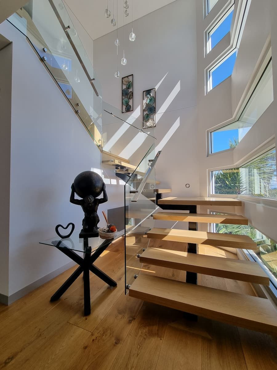 A Staircase With A Glass Railing And A Globe On A Table — South Coast Glass In South Nowra, NSW