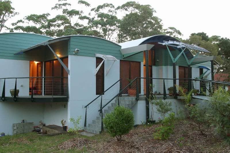 A White House With A Green Roof Is Surrounded By Trees — South Coast Glass In South Nowra, NSW
