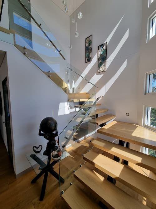A Staircase With A Glass Railing And Wooden Steps — South Coast Glass In South Nowra, NSW