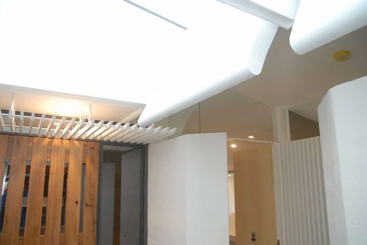 A Hallway With A Wooden Door And White Walls — South Coast Glass In South Nowra, NSW