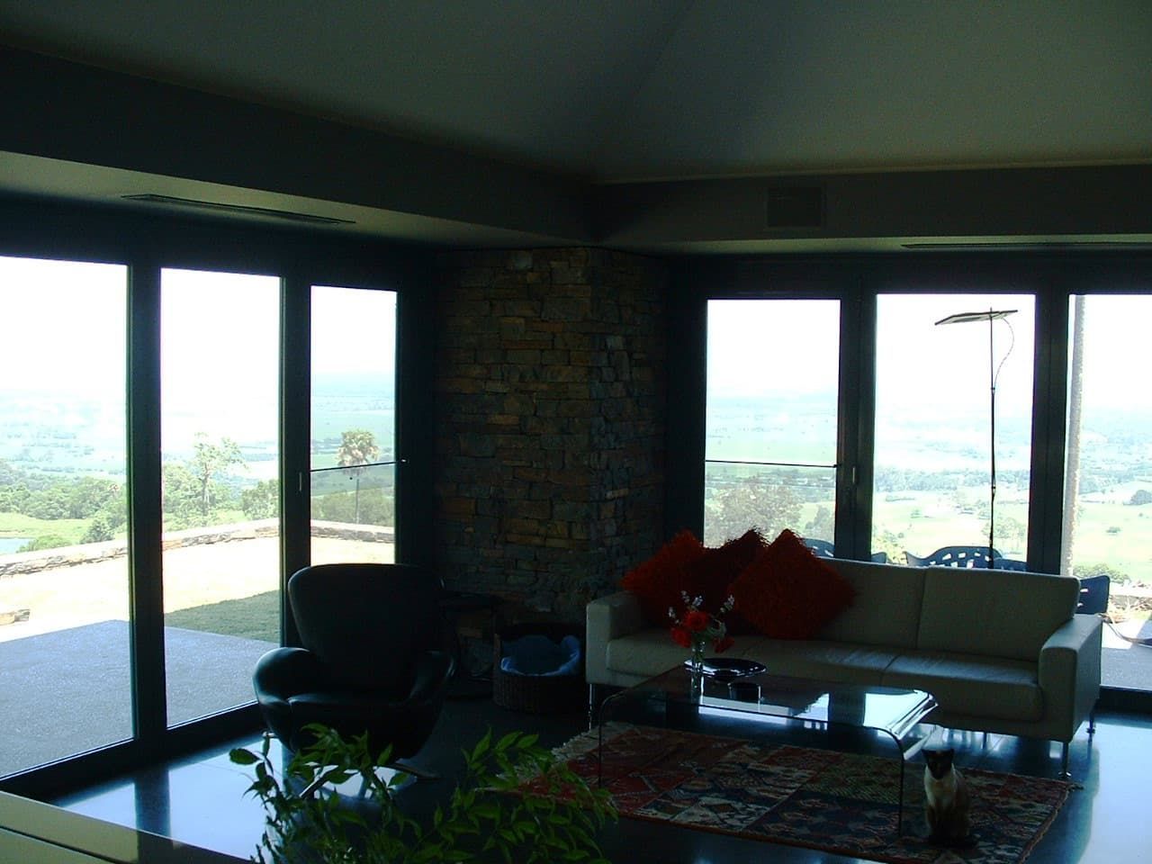 A Living Room With A Couch And Lots Of Windows — South Coast Glass In South Nowra, NSW