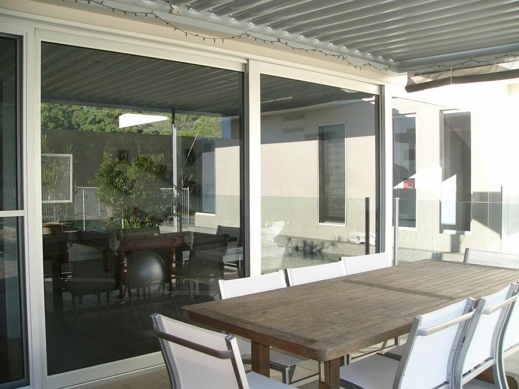 A Patio With A Table And Chairs Under A Canopy — South Coast Glass In South Nowra, NSW
