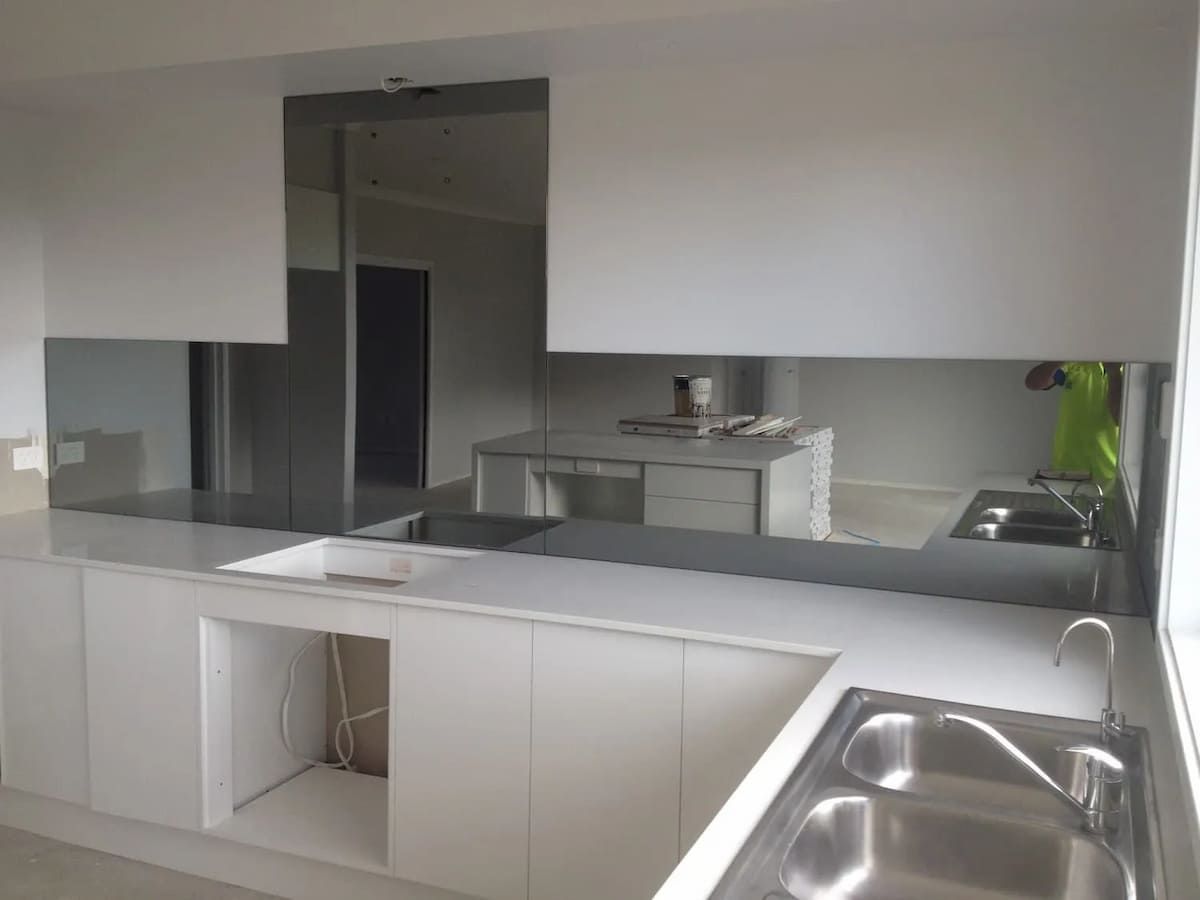 A Kitchen With White Cabinets And A Stainless Steel Sink — South Coast Glass In South Nowra, NSW