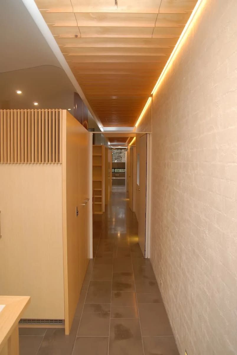 A Long Hallway With A Wooden Ceiling And Brick Walls — South Coast Glass In South Nowra, NSW