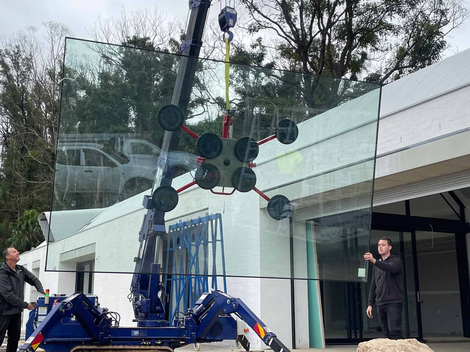 A Small Crane Installing Glass Wall — South Coast Glass In South Nowra, NSW