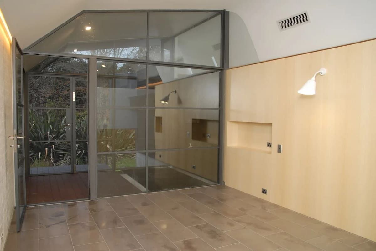 An Empty Room With A Glass Wall And A Wooden Floor — South Coast Glass In South Nowra, NSW