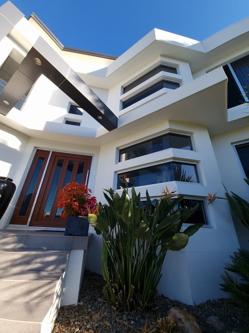A White House With A Wooden Door And Many Windows — South Coast Glass In South Nowra, NSW