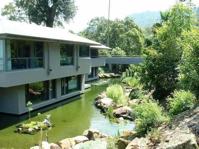 A Large House With A Pond In Front Of It — South Coast Glass In South Nowra, NSW