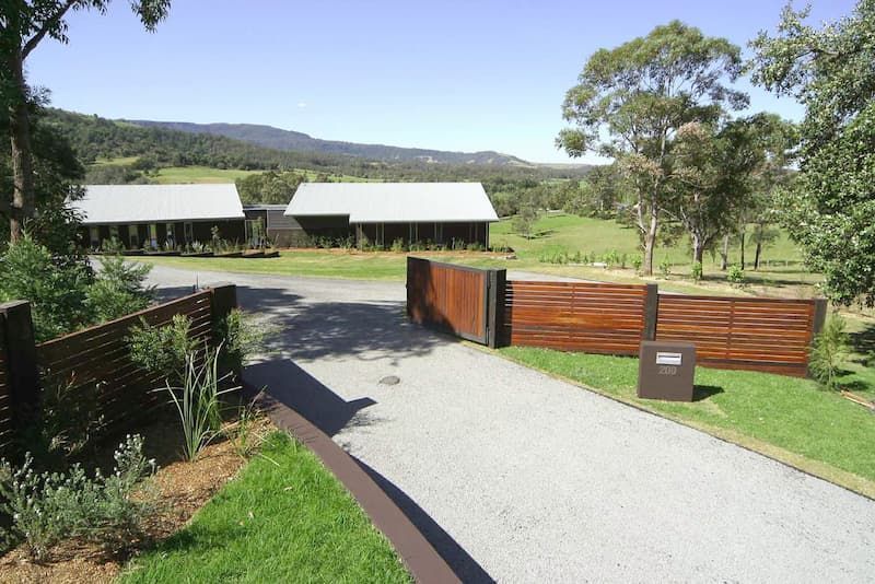 A Driveway Leading To A House With A Wooden Fence — South Coast Glass In South Nowra, NSW