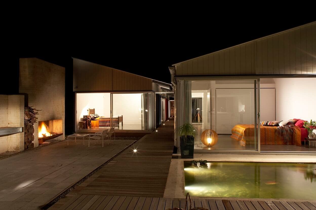 A House With A Pool And A Fireplace At Night — South Coast Glass In South Nowra, NSW