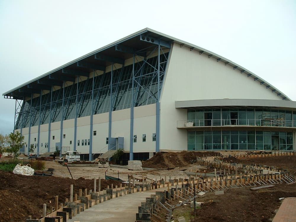 A Large Building With A Curved Roof Is Under Construction — South Coast Glass In South Nowra, NSW