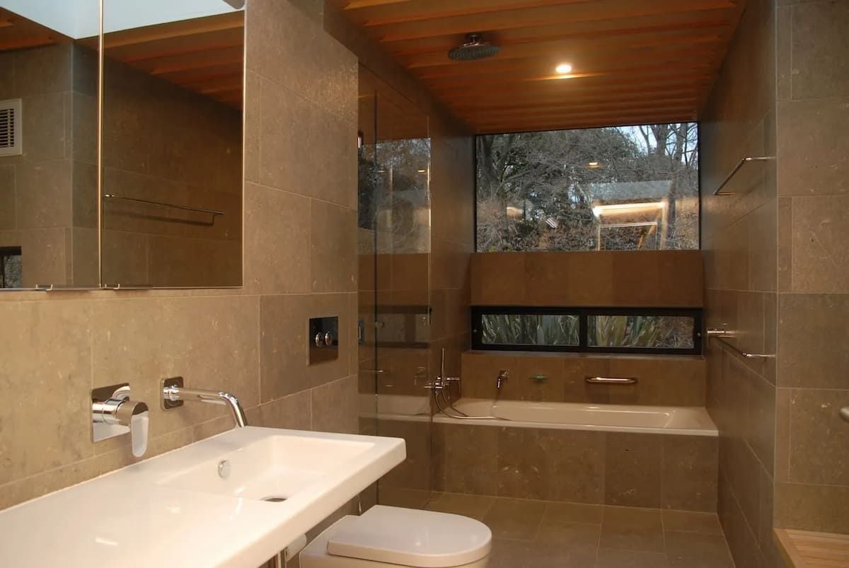 A Bathroom With A Toilet A Sink And A Bathtub — South Coast Glass In South Nowra, NSW