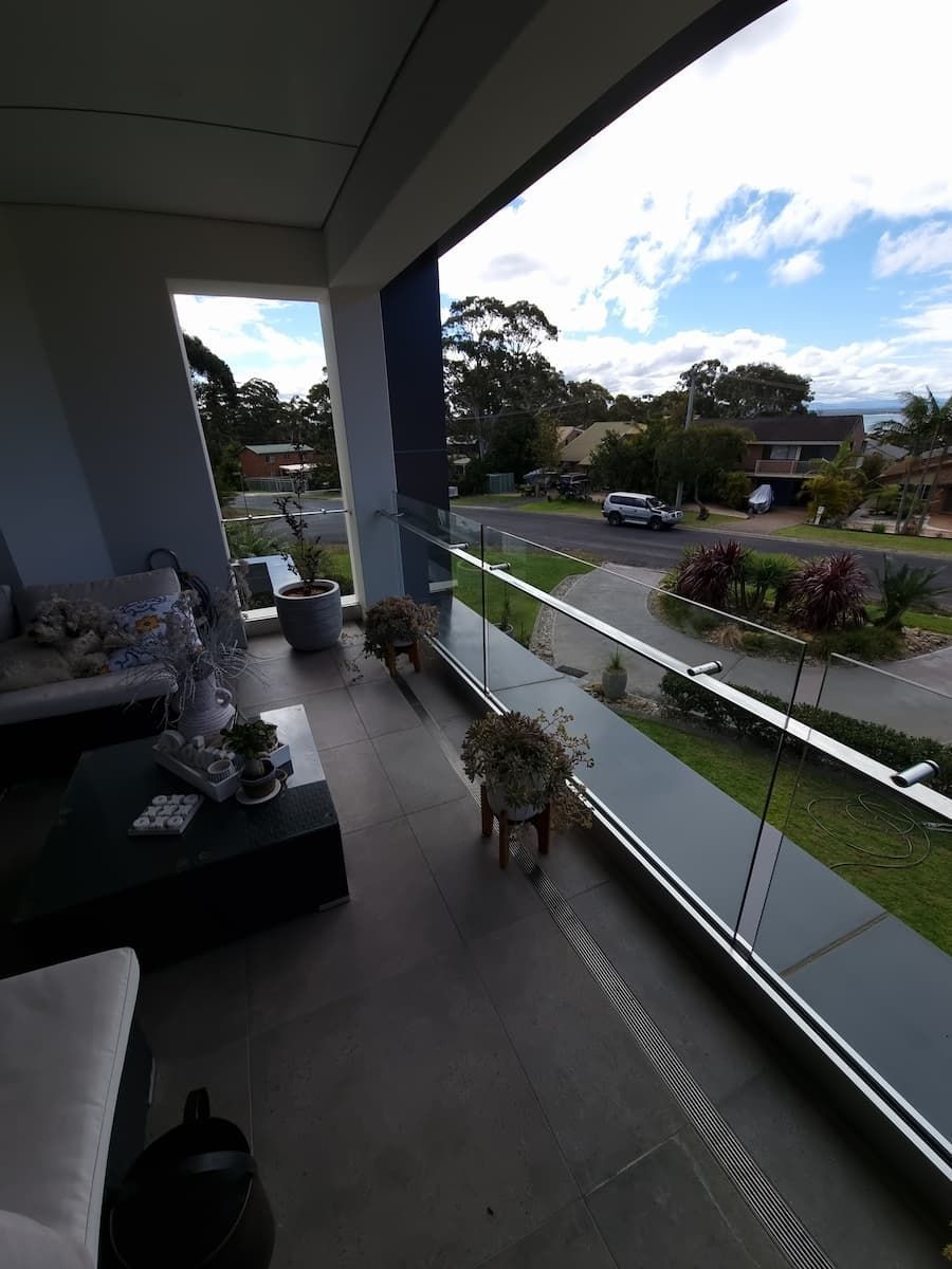 A Balcony With A View Of A Street And Trees — South Coast Glass In South Nowra, NSW