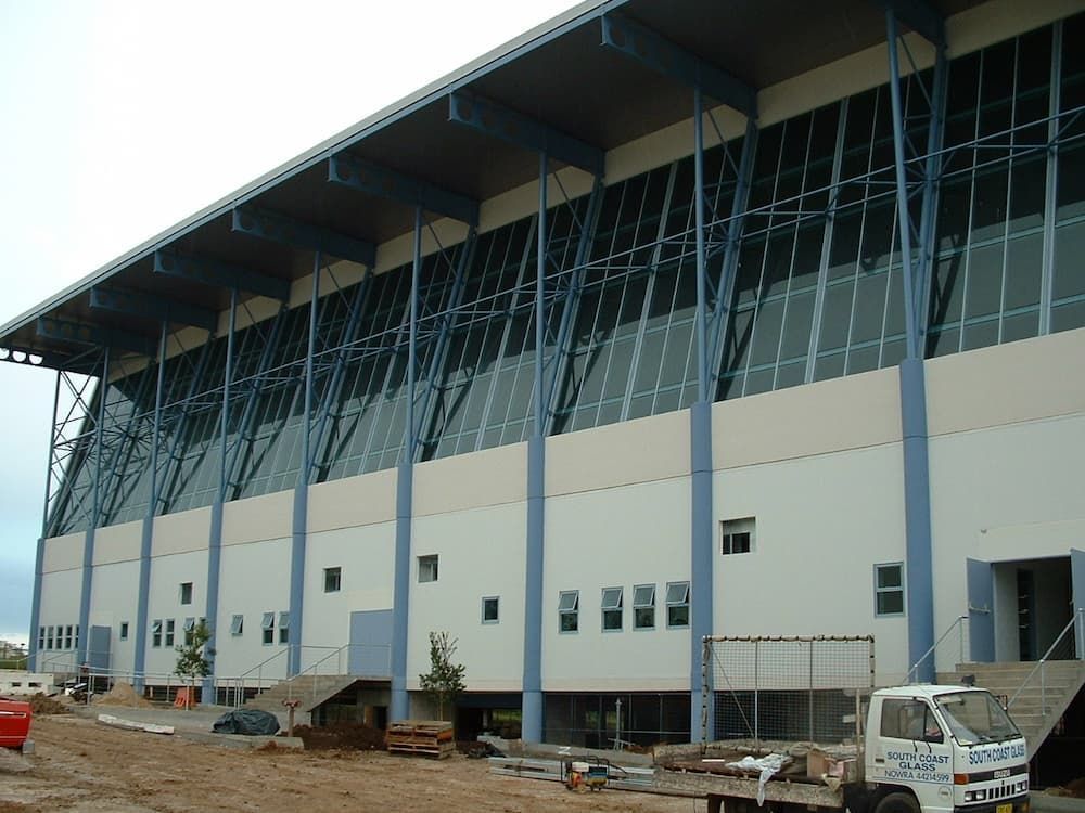 A White Truck Is Parked In Front Of A Building That Is Under Construction — South Coast Glass In South Nowra, NSW