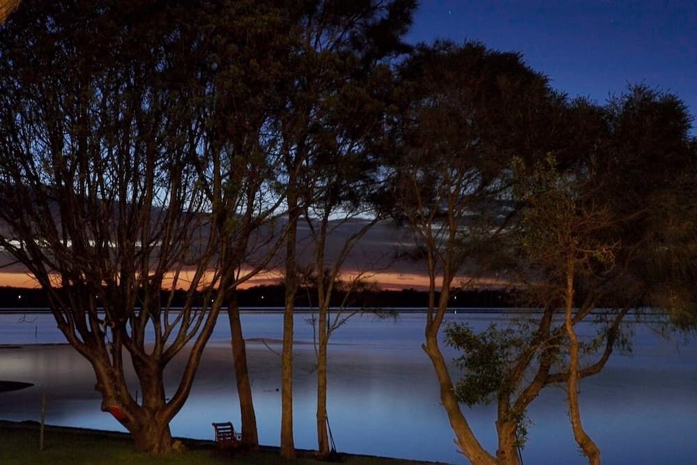 A Lake With Trees In The Foreground And Mountains In The Background — South Coast Glass In South Nowra, NSW