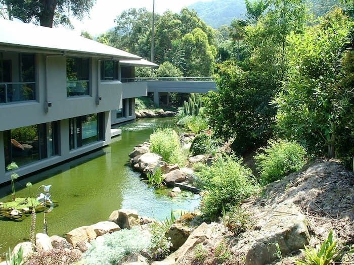 A Large Building With A Pond In Front Of It — South Coast Glass In South Nowra, NSW