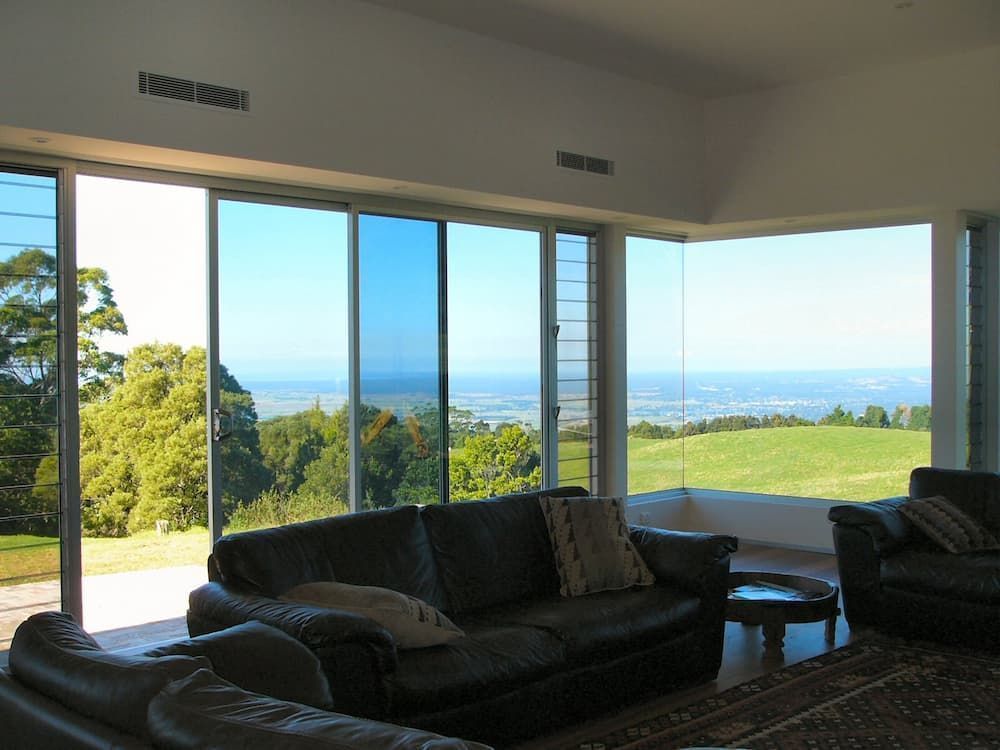 A Living Room With A Couch And Chairs And A View — South Coast Glass In South Nowra, NSW