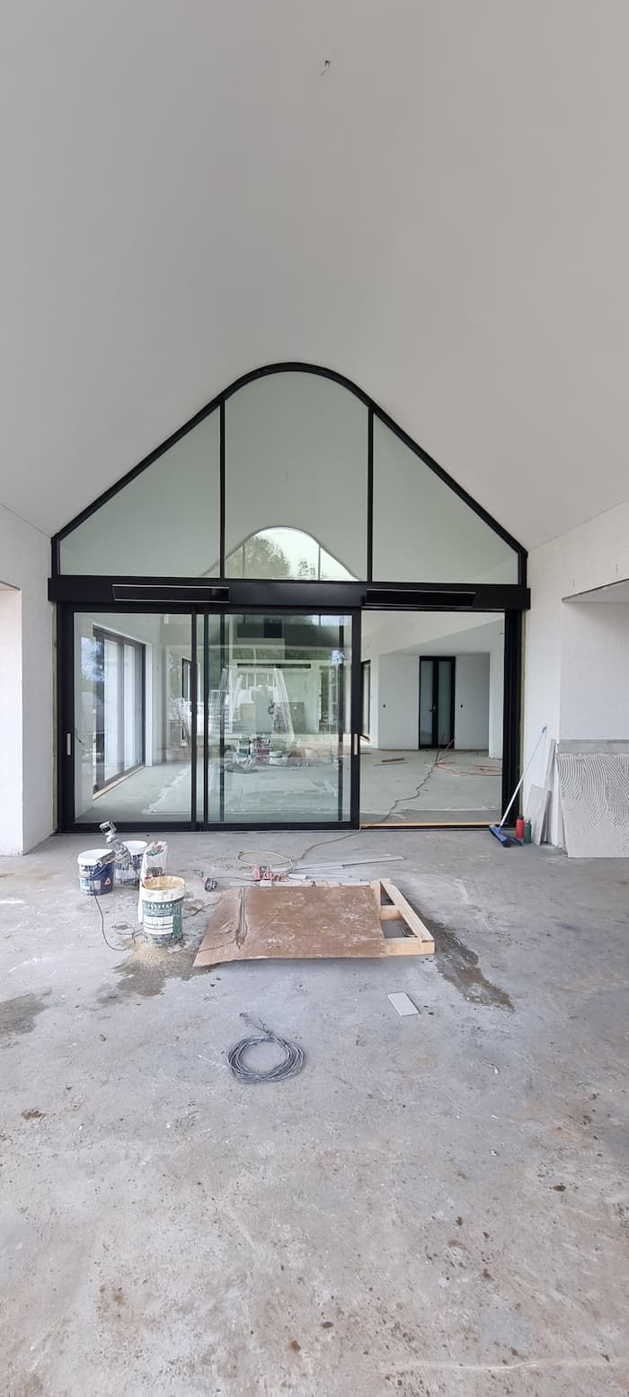 A Large Empty Room With A Sliding Glass Door And A Large Window — South Coast Glass In South Nowra, NSW