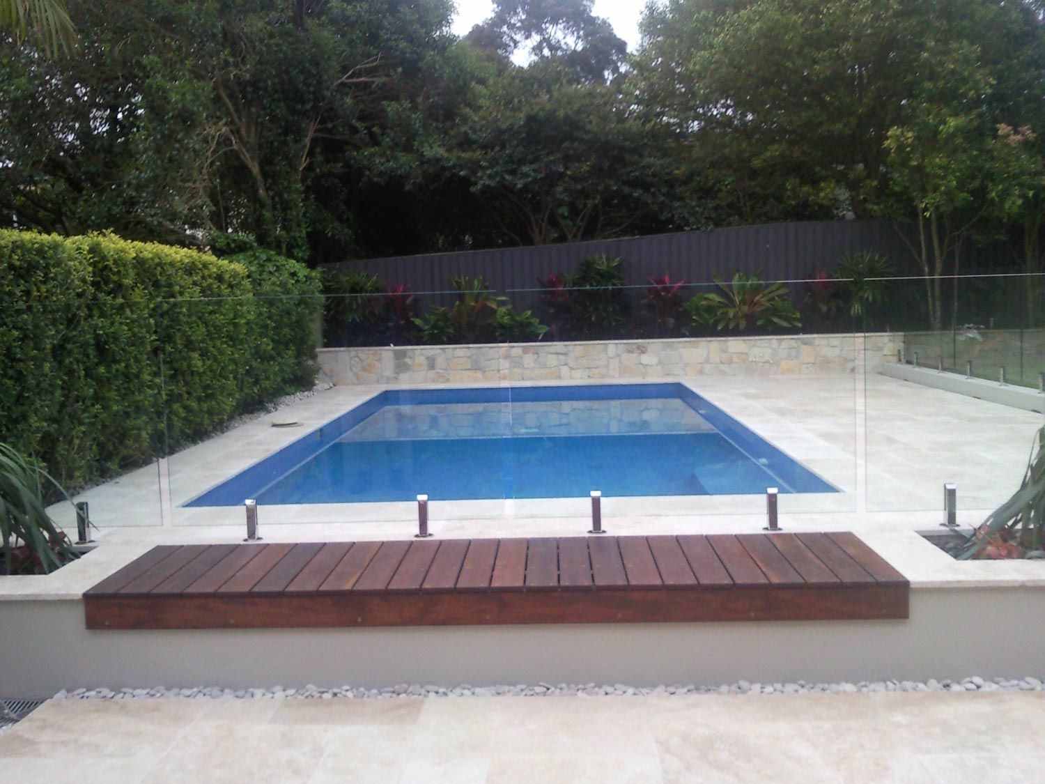 A Pool with Glass Fencing and Wood Deck — South Coast Glass In South Nowra, NSW