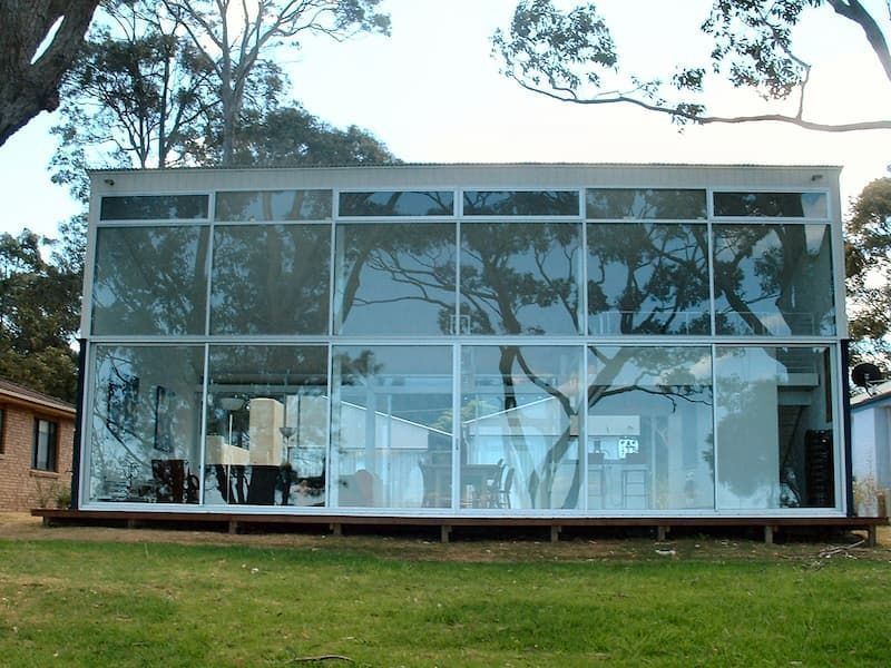 A House With A Lot Of Windows Surrounded By Trees — South Coast Glass In South Nowra, NSW