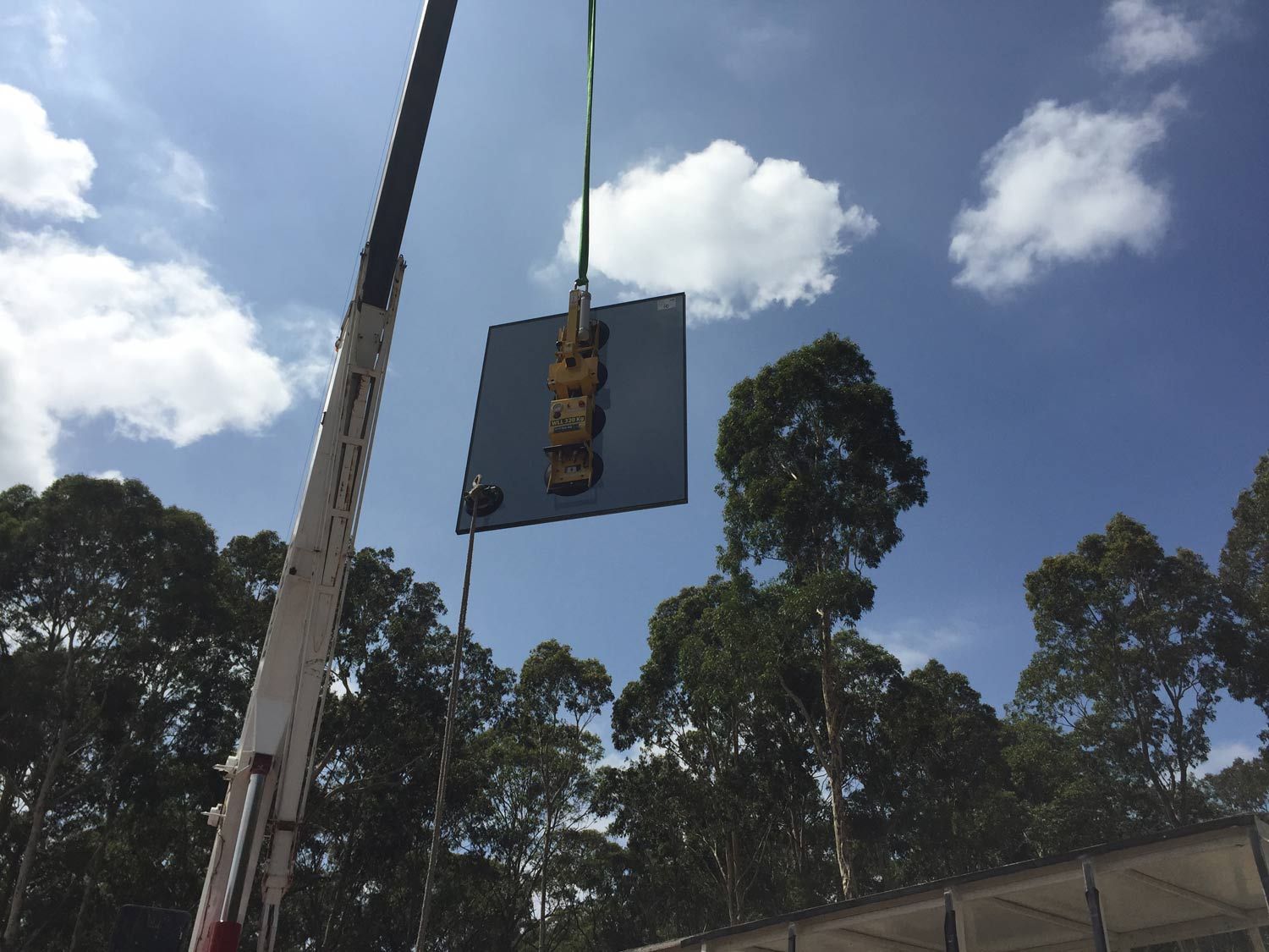 A Crane is Holding Small Piece of Glass — South Coast Glass In South Nowra, NSW