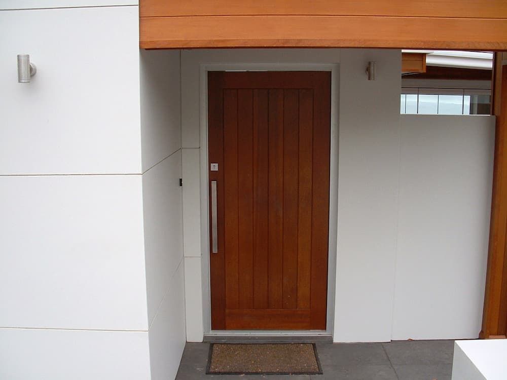 A Wooden Door With A White Wall Behind It — South Coast Glass In South Nowra, NSW