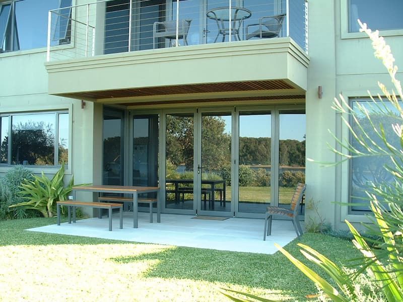A House With A Balcony And A Table And Chairs On It — South Coast Glass In South Nowra, NSW