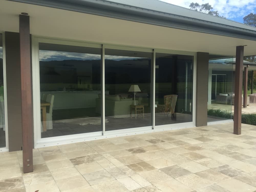 A House With A Lot Of Windows And A Patio In Front Of It — South Coast Glass In South Nowra, NSW