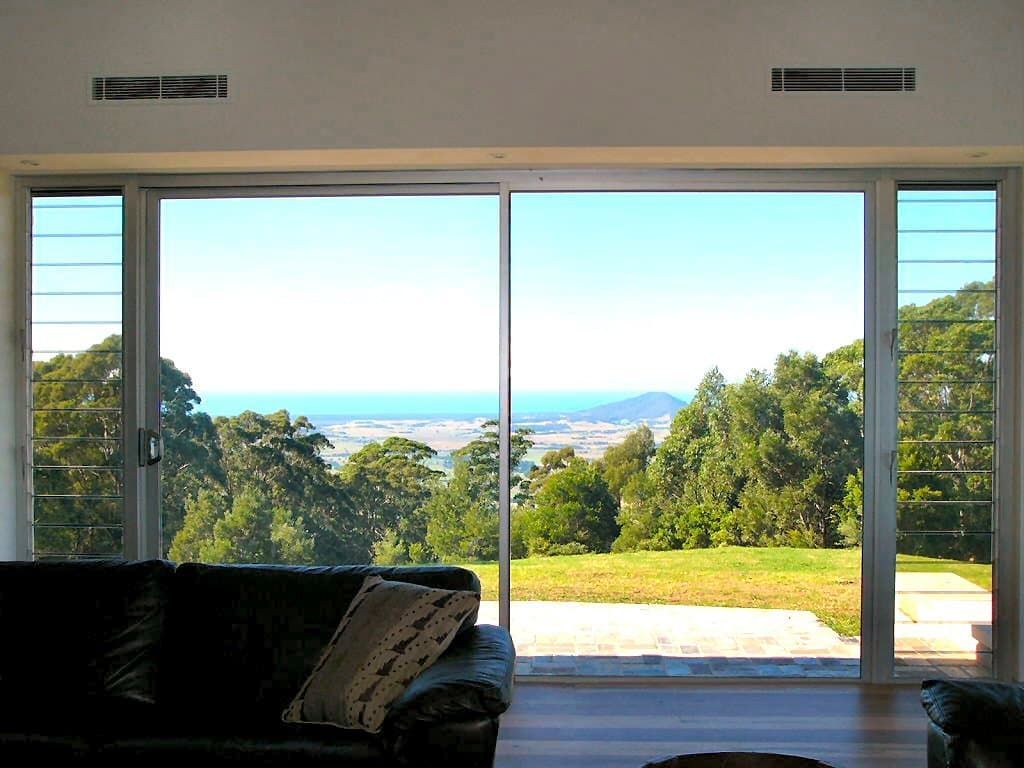 A Living Room With A View Of The Ocean And Trees — South Coast Glass In South Nowra, NSW