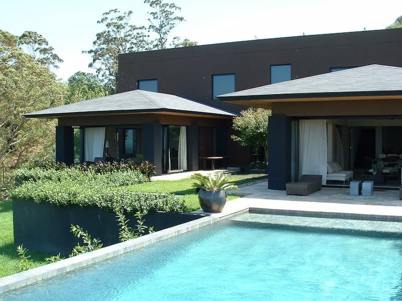 A Large House With A Swimming Pool In Front Of It — South Coast Glass In South Nowra, NSW