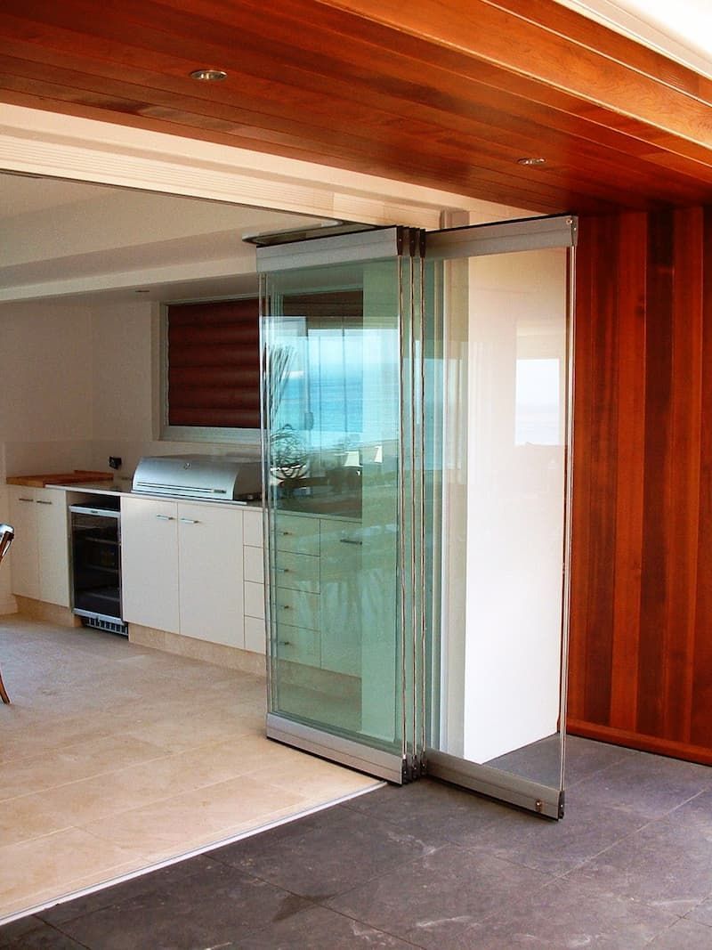 A Kitchen With A Sliding Glass Door Leading To A Patio — South Coast Glass In South Nowra, NSW