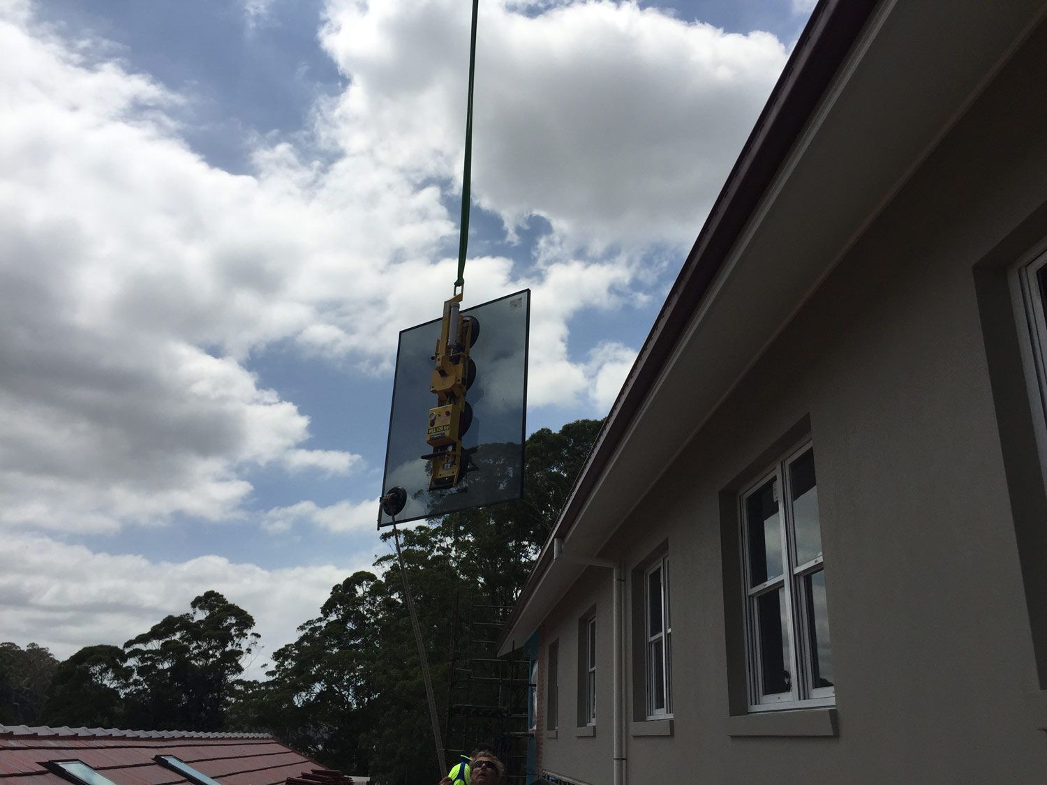 A Crane is Holding Small Window Glass — South Coast Glass In South Nowra, NSW