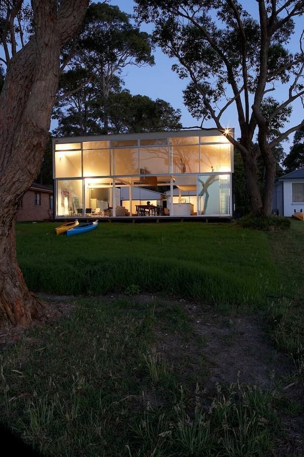 A House With A Lot Of Windows Is Lit Up At Night — South Coast Glass In South Nowra, NSW