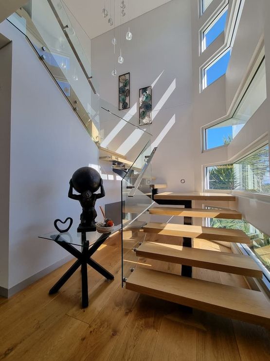 Modern staircase with glass railing and wood steps — South Coast Glass In South Nowra, NSW