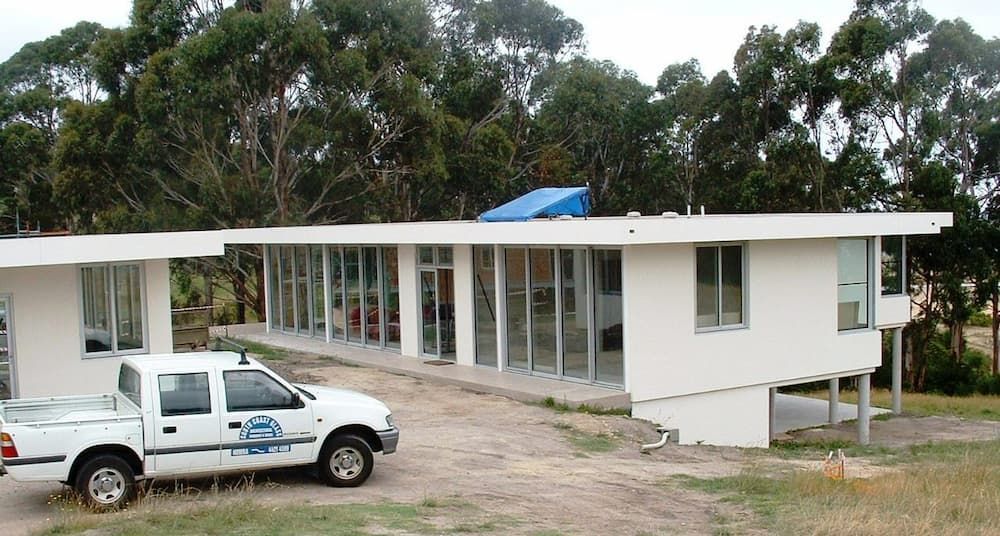 A White Truck Is Parked In Front Of A White House — South Coast Glass In South Nowra, NSW