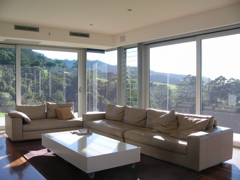 A Living Room With Two Couches And A Coffee Table — South Coast Glass In South Nowra, NSW