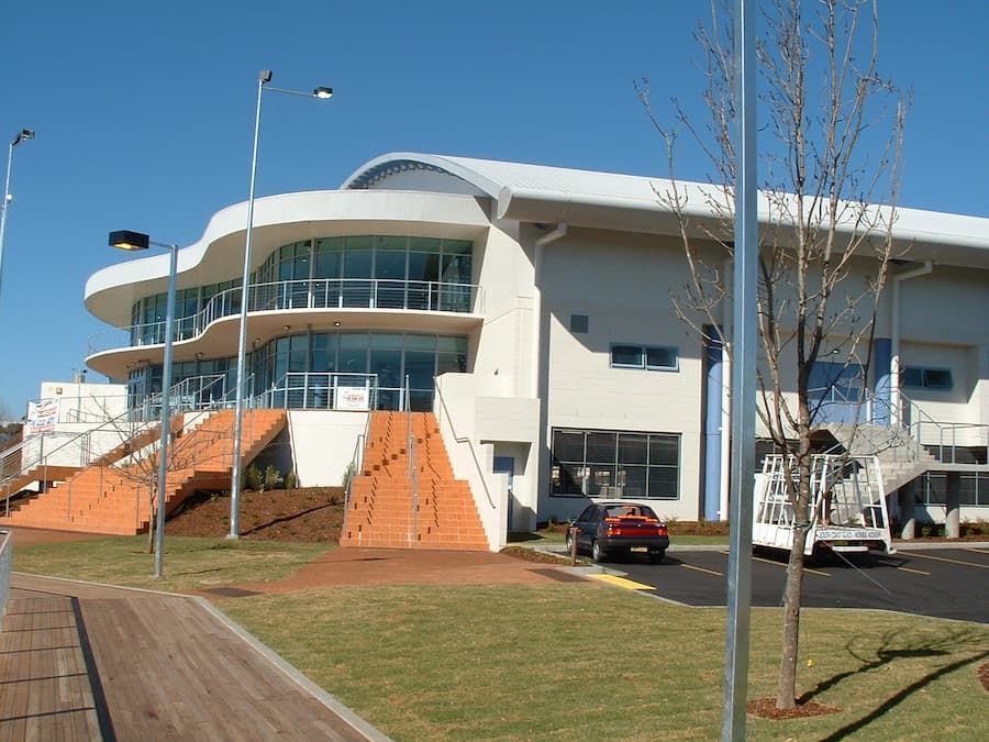 A Large White Building With Stairs Leading Up To It — South Coast Glass In South Nowra, NSW